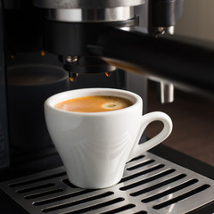 White ceramic cup of fresh espresso with foam