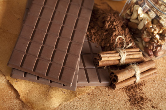 Chocolate bars, cocoa, cinnamon sticks and nuts