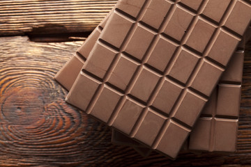 Chocolate bars on old wooden wall