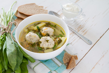 Sorrel soup in white bowl