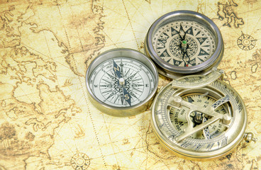 Naklejka na ściany i meble compass on a old world map