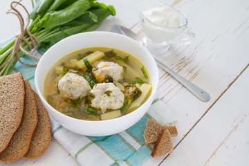 Sorrel soup in white bowl