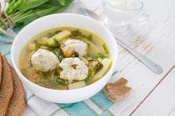 Sorrel soup in white bowl