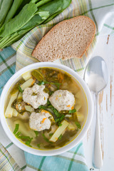 Sorrel soup in white bowl