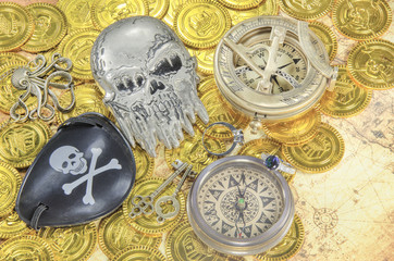steel pirate skull compass on a pirate golden coins