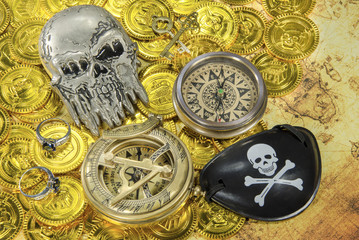 steel pirate skull compass on a pirate golden coins