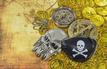 steel pirate skull compass on a pirate golden coins