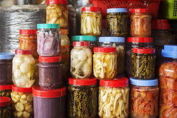jars of asian style pickles in kep market cambodia