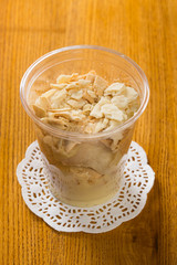 Creamy dessert in plastic cup