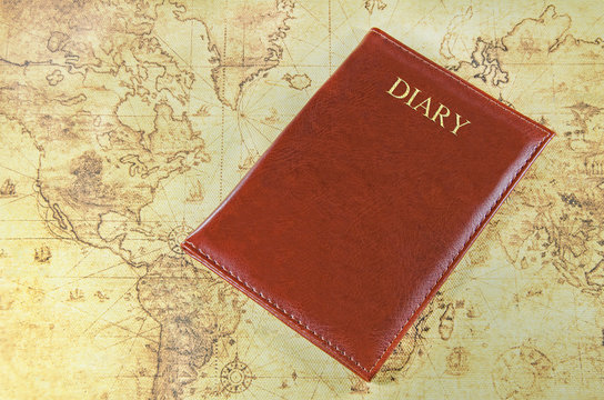 mini notebook on a old world map