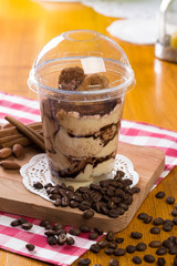 Creamy dessert in plastic cup