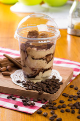 Creamy dessert in plastic cup