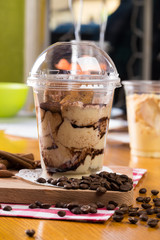 Creamy dessert in plastic cup