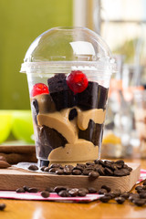 Creamy dessert in plastic cup