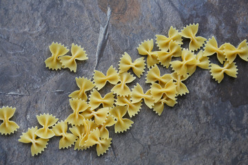 raw farfalle on stone