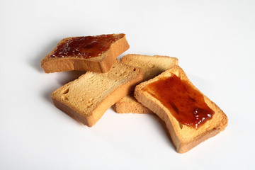 four biscuits with jam on white