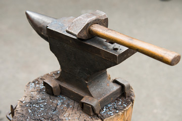 blacksmith hammer lying on anvil