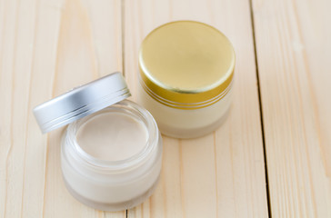 Cream container on white background