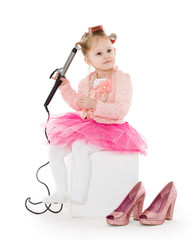 Little girl with curling iron.
