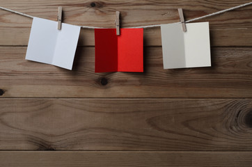 Three Opened Greetings Cards Pegged on String Against Wood Plank © Franny-Anne