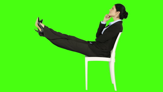 Business woman relaxing on a chair with legs up