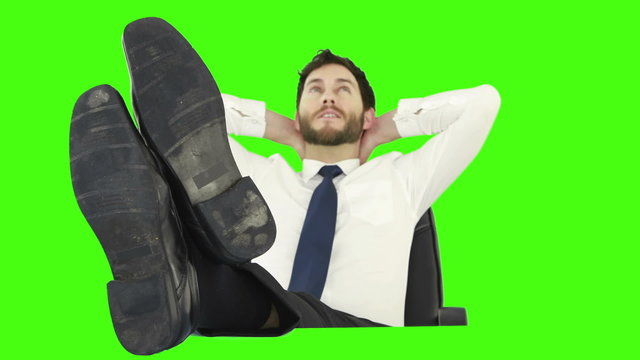 Businessman relaxing in his chair with legs up