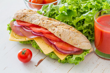 Sandwich with cheese abd ham, salad and tomatoes