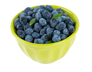 Honeysuckle berries in  a bowl isolated on white