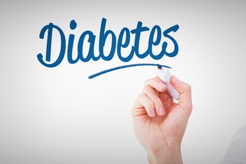 Diabetes against businessmans hand writing with marker