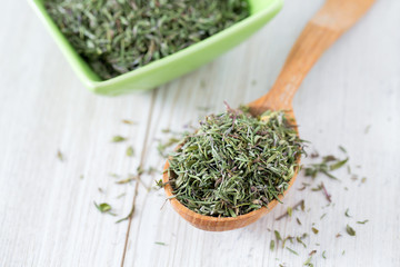 dried thyme on wooden surface