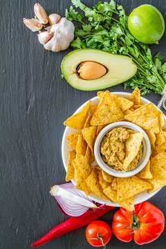 Guacamole sauce, nachos and ingredients