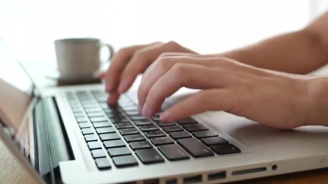 4K Woman's hands typing on laptop PC. Freelancer use the internet to work from home.  