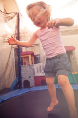 Toddler jumping on a trampoline