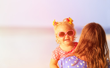 mother and cute little daughter at beach