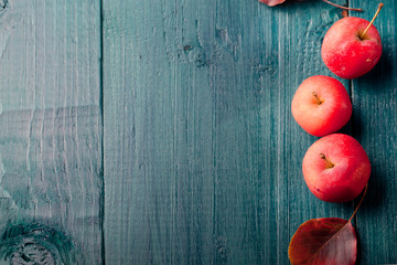 Red apples and leaves Wooden blue, turquoise background
