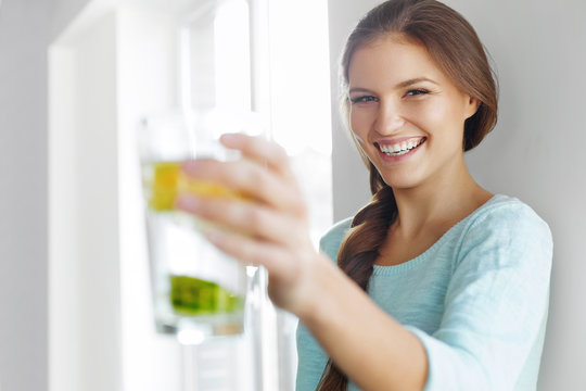 Healthy Lifestyle Concept, Diet And Fitness. Woman Drinking Water With Lemon , Lime And Mint