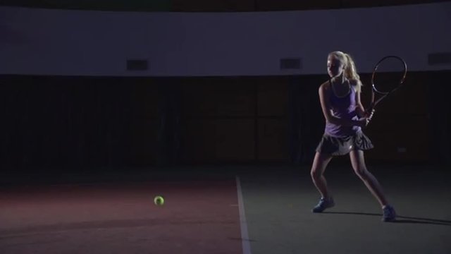 Tennis shots: Backhand (slow motion). Attractive girl playing tennis. Professional tennis player