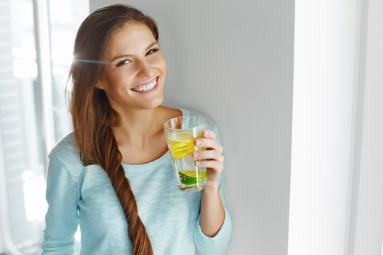 Healthy Lifestyle And Food. Woman Drinking Fruit Water. Detox. 