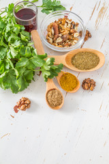 Georgian sauce ingredients on white wood background