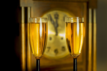 Glasses of champagne on the background of the old clock © GieZetStudio