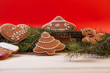 Christmas cookies with festive decoration on the red background.