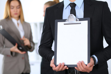 Unknown businessman holds clipboard with copy space area