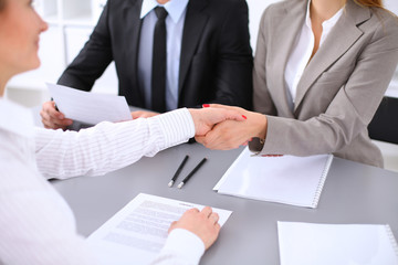 Business people shaking hands, finishing up a meeting. Copy space  at the left corner