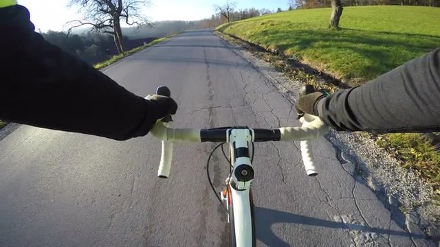 4K POV Road cycler cycling through countryside on a beautiful sunny day in fall