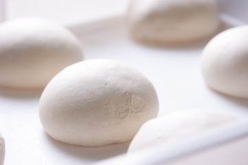Pizza ball dough on white tray 