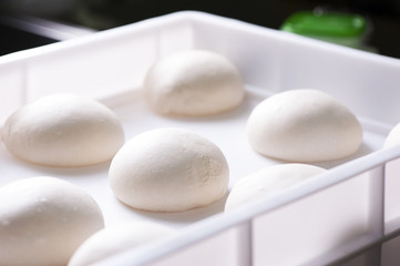 Fototapeta na wymiar Pizza ball dough on white tray