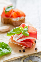 Bruschetta and ingredients on rustic wood background