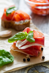 Bruschetta and ingredients on rustic wood background