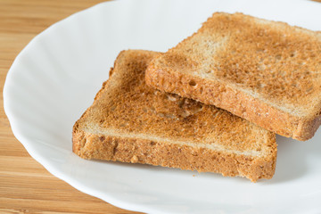 Two pieces of toast on white plate