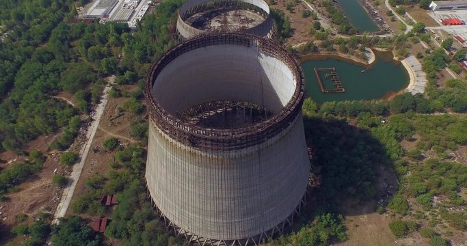Aerial view. Cooling towers unfinished srade of the Chernobyl nuclear power plant. Flying at Chernobyl disaster zone. Ukraine.